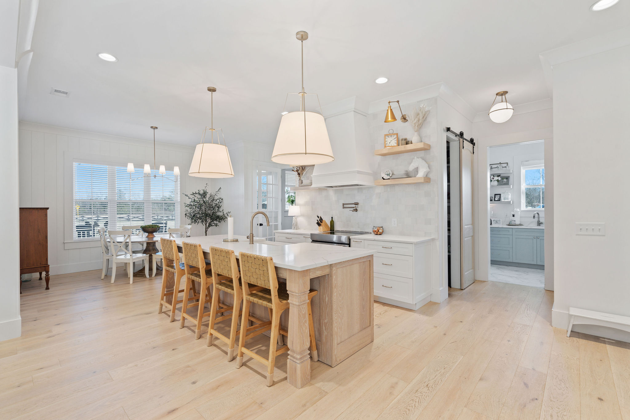 Kitchen with a natural oak island and white cabinetry