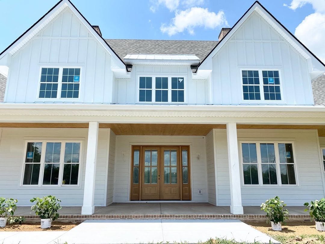 Glazed timber front doors and a wood ceiling at the farmhouse porch