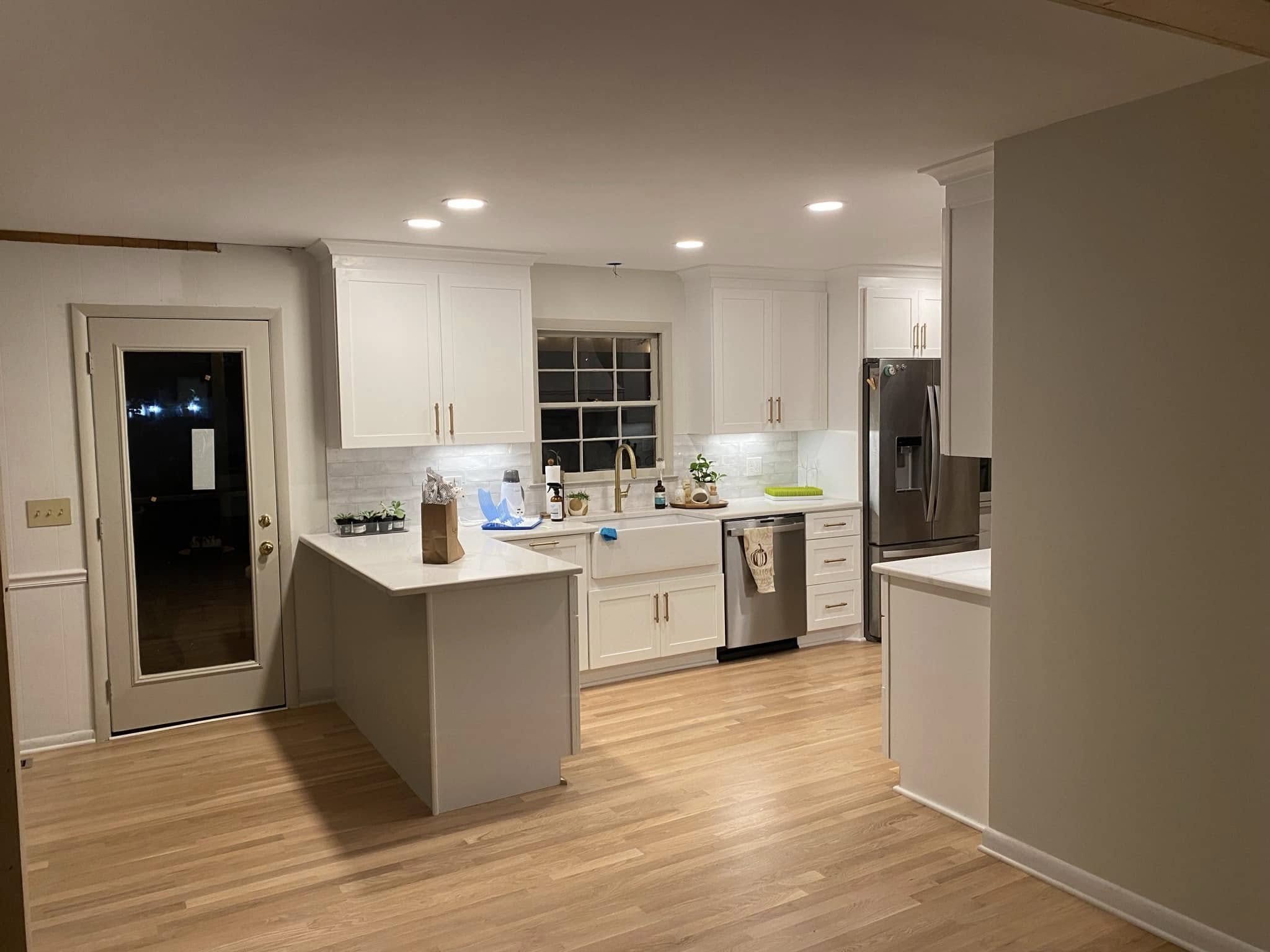 Another view of the renovated kitchen and its connection to the surrounding space